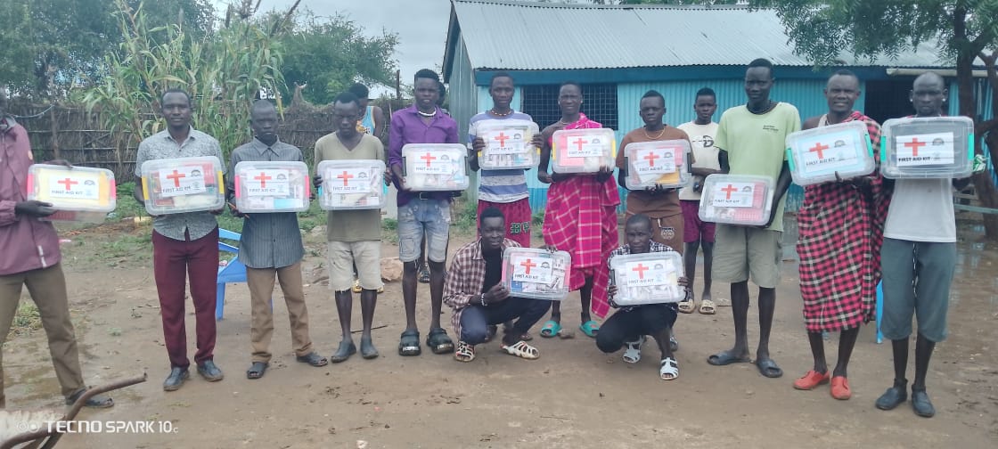 Local church leaders holding first aid kits following their training.