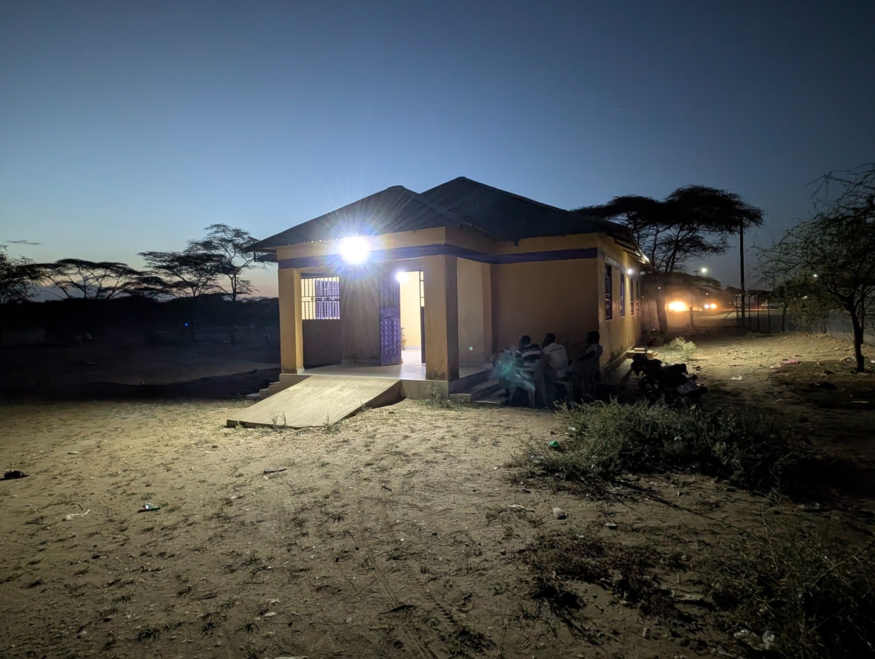 Nyakica Medical Centre illuminated in the evening.